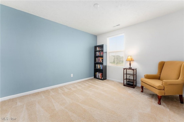 living area with light colored carpet