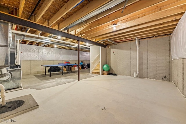 basement featuring brick wall