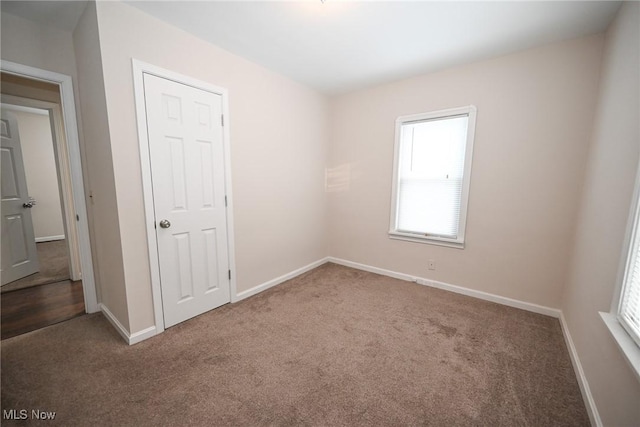 unfurnished room featuring carpet