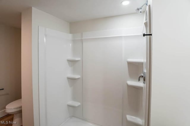 bathroom featuring toilet and a shower