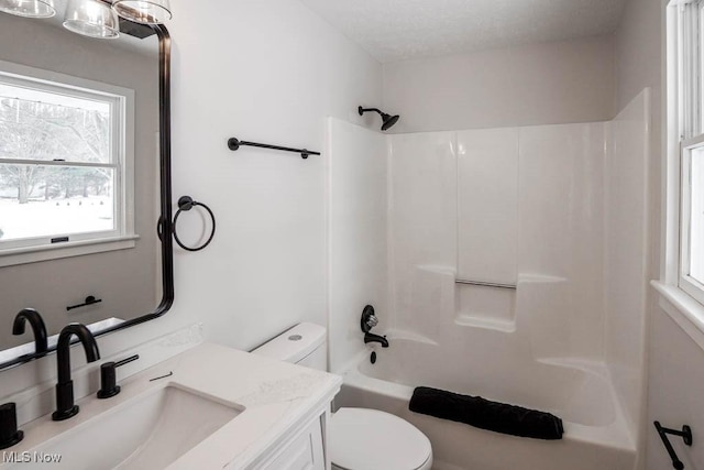 full bathroom featuring tub / shower combination, toilet, a wealth of natural light, and vanity