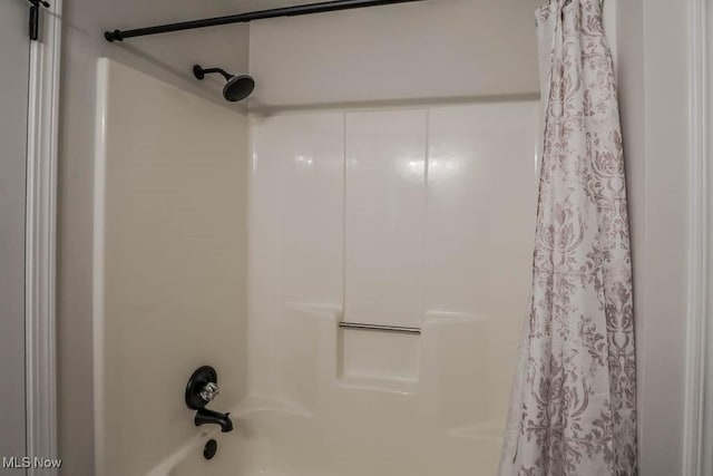 details featuring shower / bathtub combination with curtain