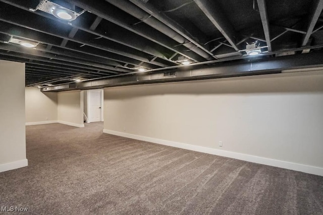 basement featuring dark colored carpet