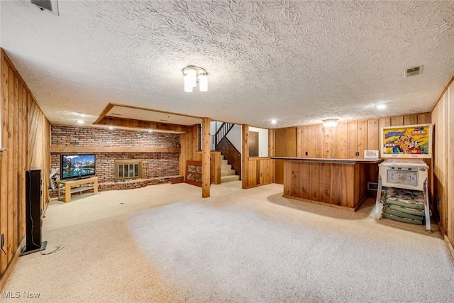 bar featuring wooden walls, a fireplace, and light carpet