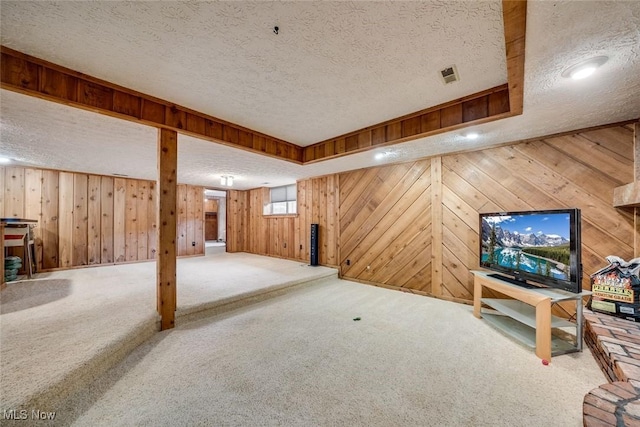 basement with carpet and a textured ceiling