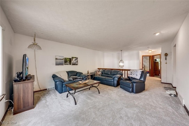 living room with light carpet and a textured ceiling