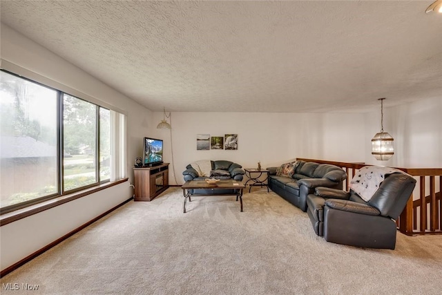 living room featuring carpet and a textured ceiling