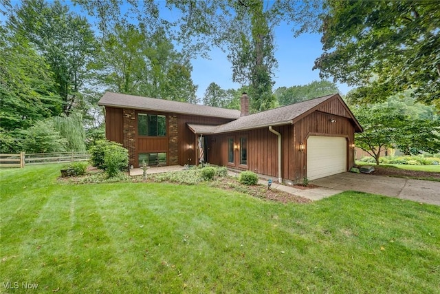 ranch-style house featuring a garage and a front yard