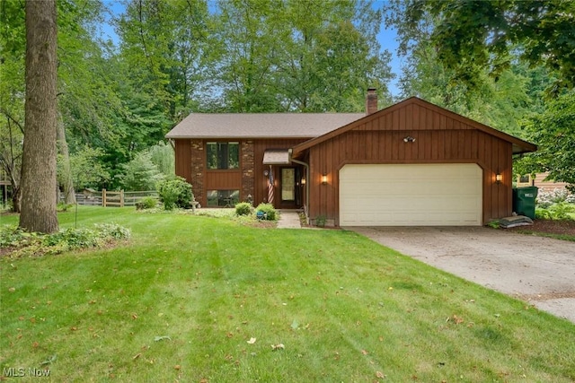 view of front of house featuring a garage and a front lawn