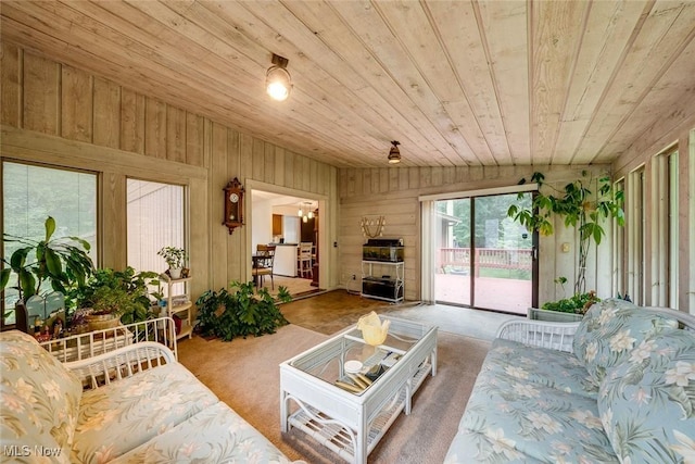 carpeted living room featuring wooden ceiling