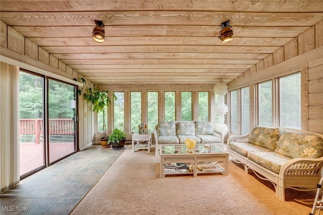 sunroom / solarium with wooden ceiling, a healthy amount of sunlight, and lofted ceiling