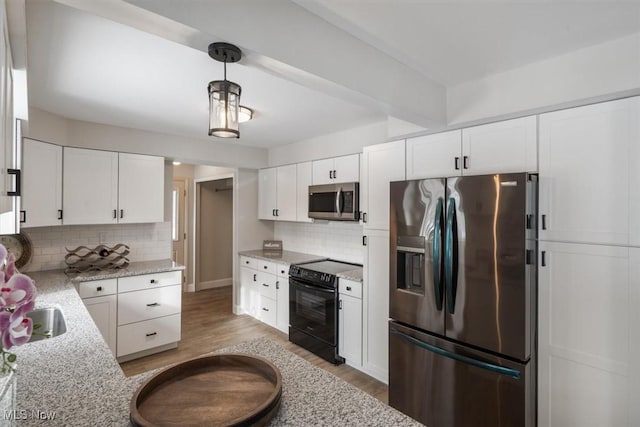 kitchen featuring light hardwood / wood-style floors, decorative backsplash, white cabinets, decorative light fixtures, and stainless steel appliances