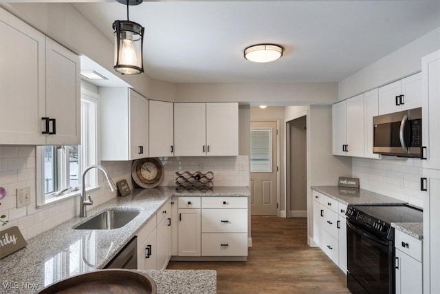 kitchen featuring pendant lighting, dark wood-type flooring, white cabinetry, stainless steel appliances, and sink