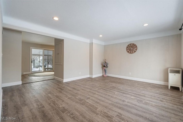 unfurnished room with hardwood / wood-style floors and ornamental molding