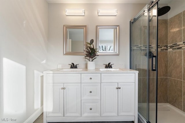 bathroom featuring vanity and an enclosed shower