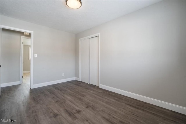 unfurnished room featuring dark hardwood / wood-style flooring