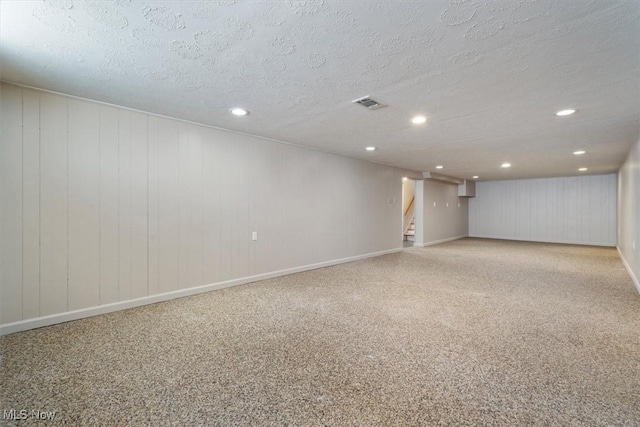 basement featuring a textured ceiling