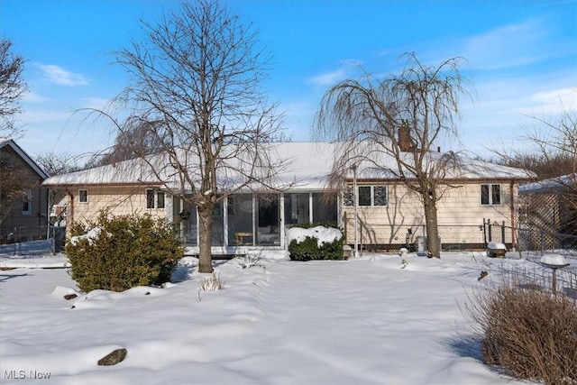 view of snow covered rear of property