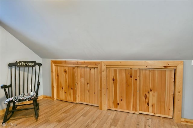 bonus room featuring vaulted ceiling and light wood-type flooring