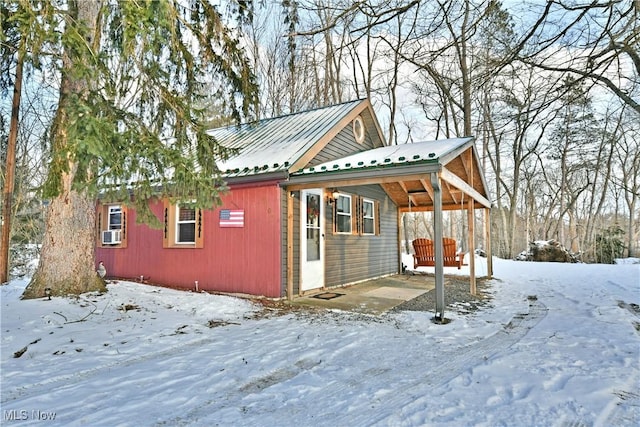 view of snow covered exterior with cooling unit