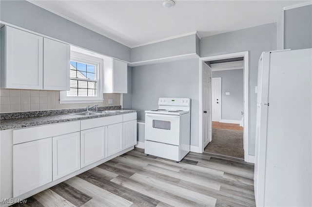 kitchen with white cabinetry, sink, and white appliances