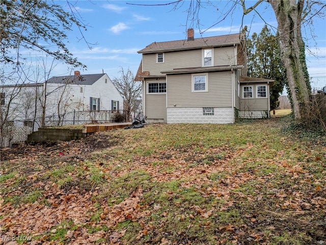 rear view of property with a yard