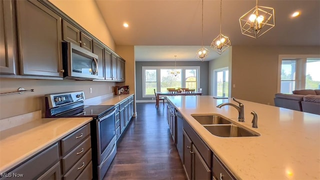 kitchen featuring sink, decorative light fixtures, dark hardwood / wood-style floors, and appliances with stainless steel finishes