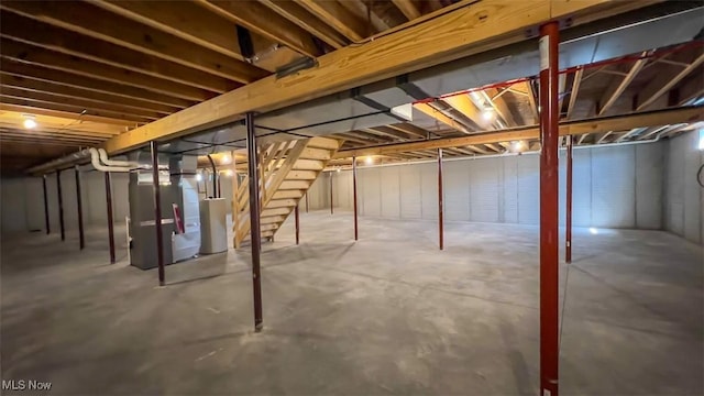 basement featuring heating unit and gas water heater