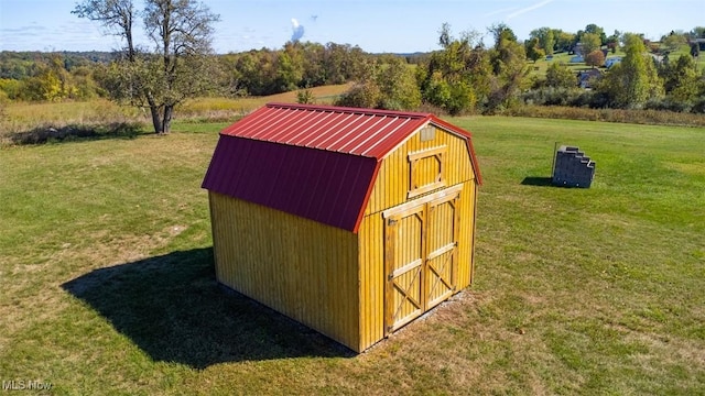 view of outdoor structure featuring a lawn