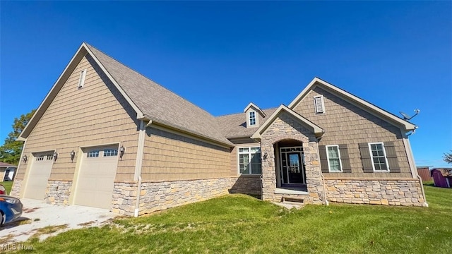 view of front of home with a garage and a front yard