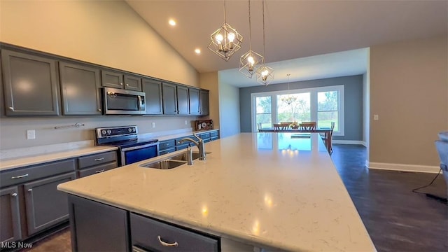 kitchen with pendant lighting, sink, light stone countertops, high vaulted ceiling, and stainless steel appliances