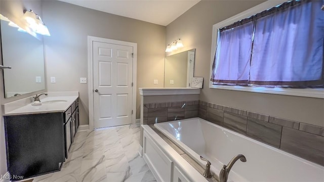 bathroom featuring vanity and a tub to relax in