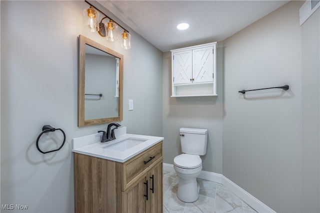 bathroom featuring vanity and toilet