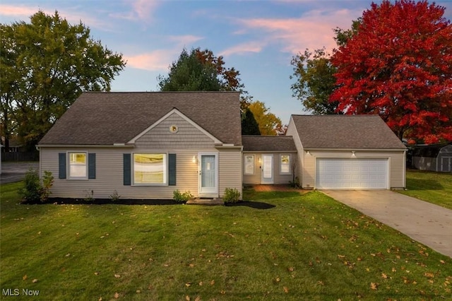 view of front of property featuring a garage and a yard