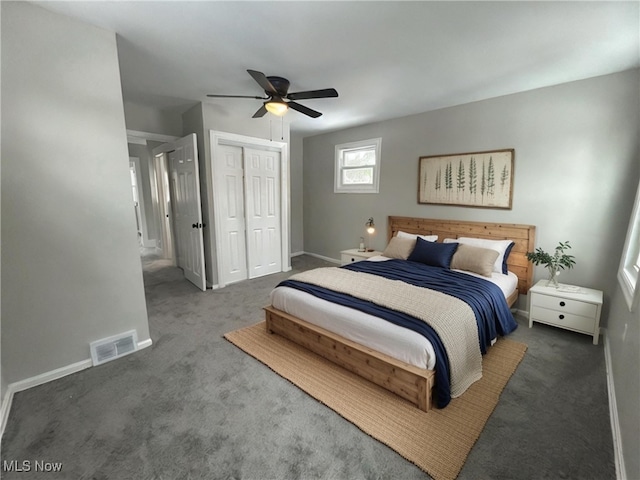 bedroom with a closet, ceiling fan, and dark carpet