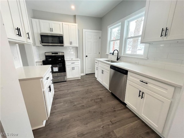 kitchen featuring sink, white cabinetry, appliances with stainless steel finishes, and tasteful backsplash