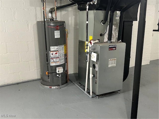 utility room with heating unit and water heater