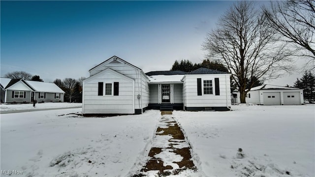 view of front facade featuring an outdoor structure and a garage