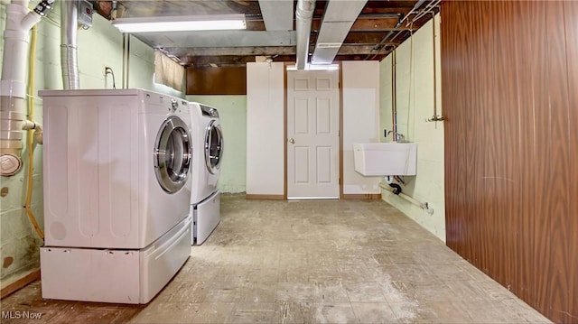 laundry area featuring sink and separate washer and dryer