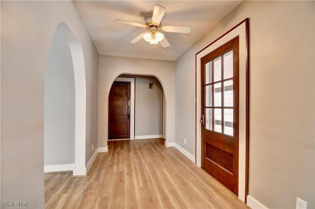 doorway to outside featuring light wood-type flooring and ceiling fan