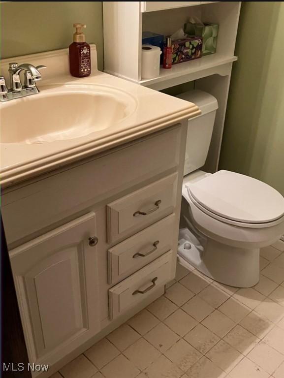 bathroom featuring vanity, toilet, and tile patterned flooring