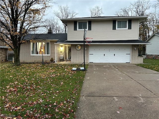 tri-level home with a front yard and a garage