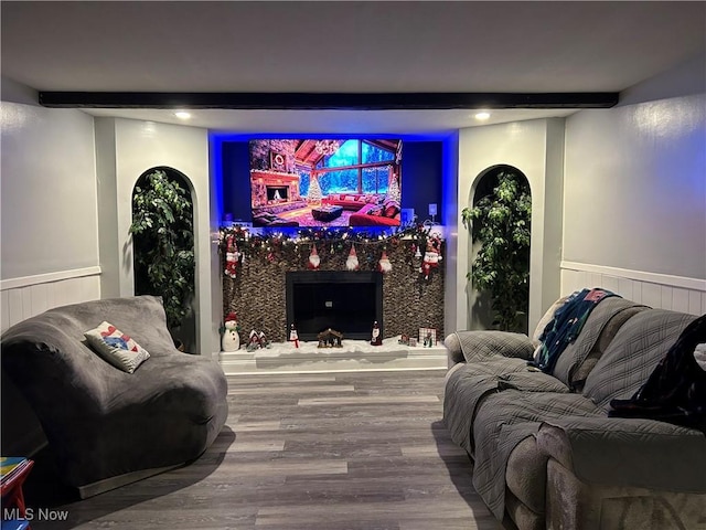 home theater featuring hardwood / wood-style floors and beam ceiling