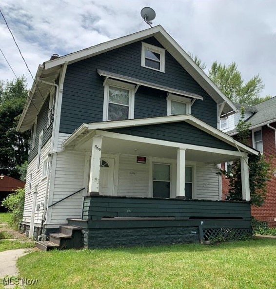 view of front of home featuring a front yard and a porch