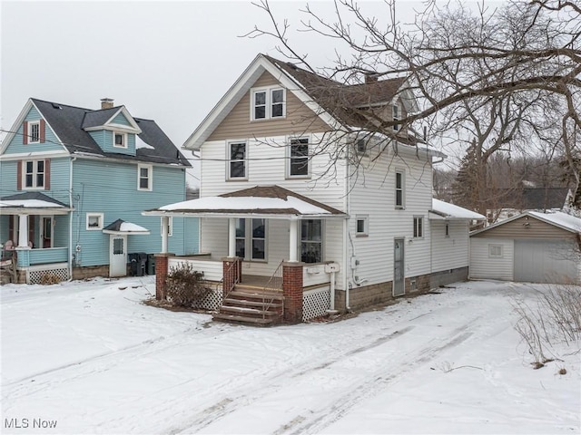 view of front of home with a garage, an outbuilding, and covered porch