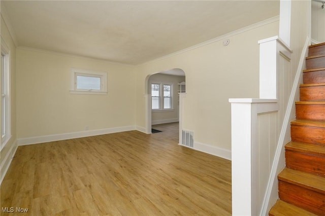 unfurnished room featuring crown molding and light wood-type flooring