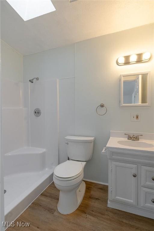 bathroom featuring walk in shower, wood-type flooring, toilet, and a skylight