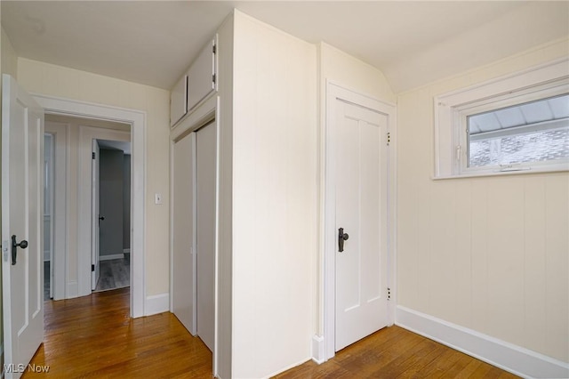 hallway with hardwood / wood-style floors