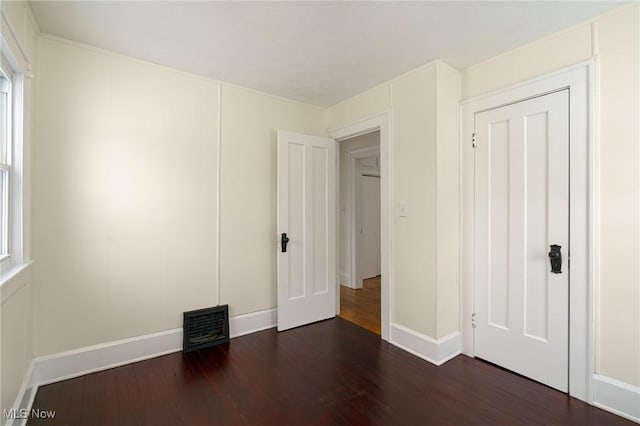 unfurnished bedroom featuring dark hardwood / wood-style floors