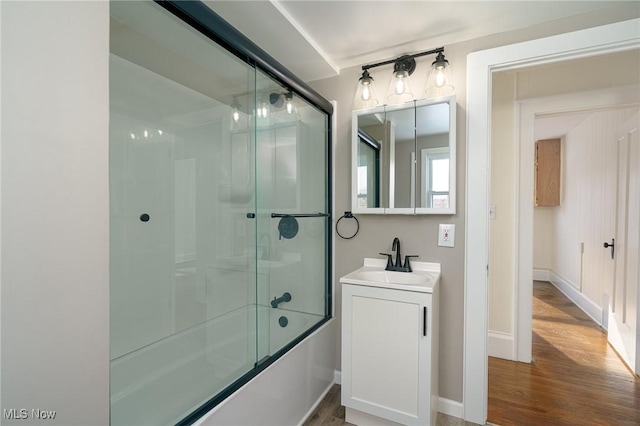 bathroom featuring vanity, bath / shower combo with glass door, and hardwood / wood-style floors